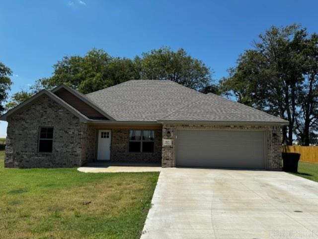 view of front of home with a garage and a front yard