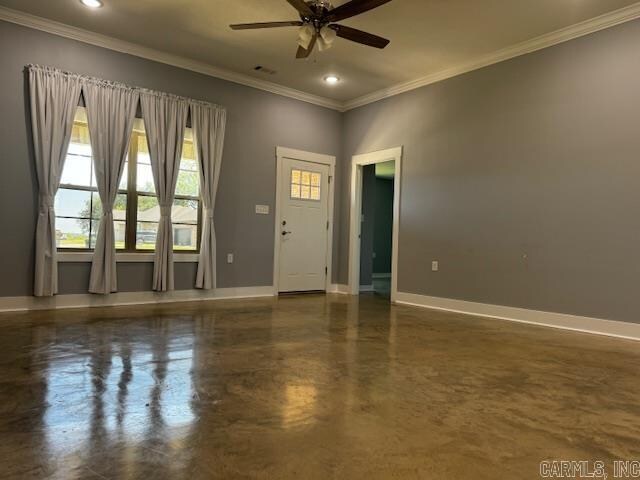 empty room with ceiling fan and crown molding