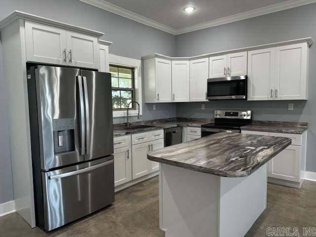 kitchen with a kitchen island, white cabinets, sink, crown molding, and stainless steel appliances