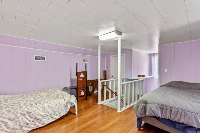 bedroom featuring light wood finished floors and visible vents