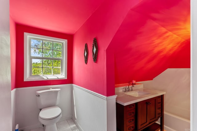 bathroom with toilet, tile patterned flooring, a washtub, and vanity