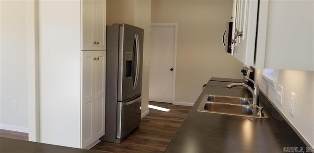 kitchen featuring white cabinetry, sink, stainless steel appliances, and dark hardwood / wood-style flooring