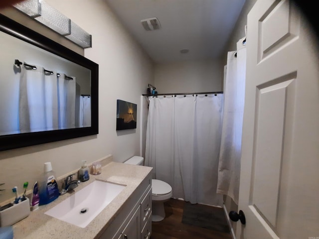 full bathroom featuring plus walk in shower, toilet, vanity, and hardwood / wood-style flooring