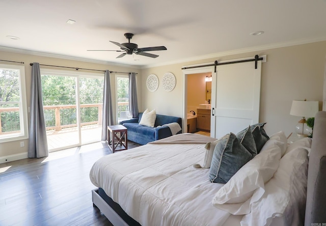 bedroom with ceiling fan, a barn door, wood-type flooring, and ornamental molding