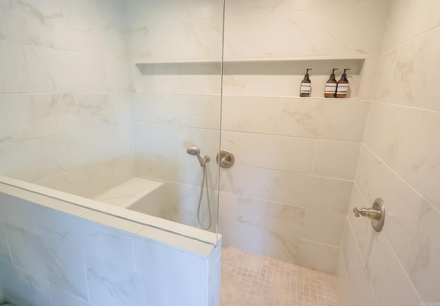 bathroom with a tile shower