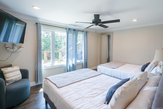 bedroom with ceiling fan, dark hardwood / wood-style floors, and ornamental molding