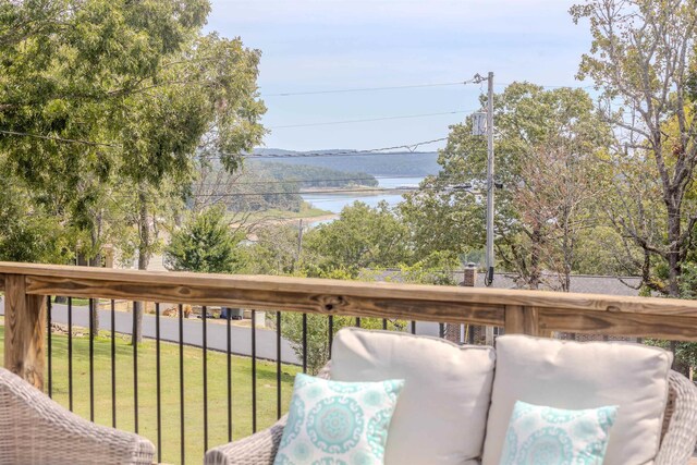 wooden deck featuring a water view and a yard