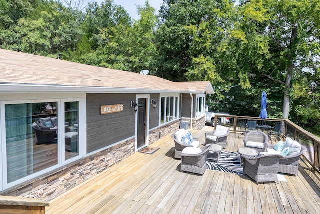 wooden terrace featuring an outdoor living space