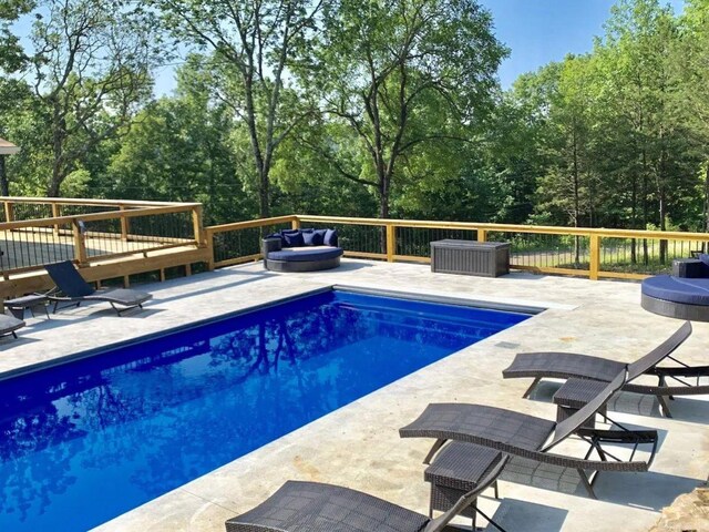 view of swimming pool featuring a deck