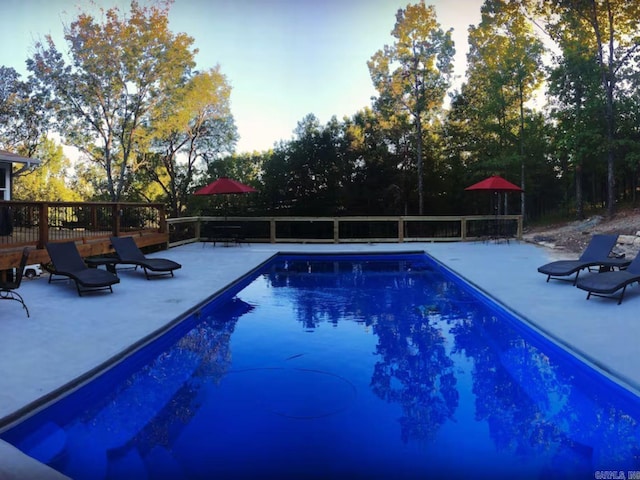 view of pool with a deck and a patio