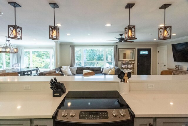 kitchen featuring ceiling fan, pendant lighting, ornamental molding, and stove