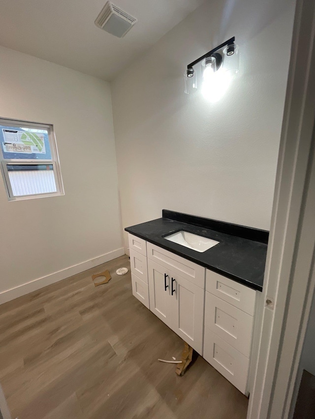 bathroom featuring vanity and hardwood / wood-style floors