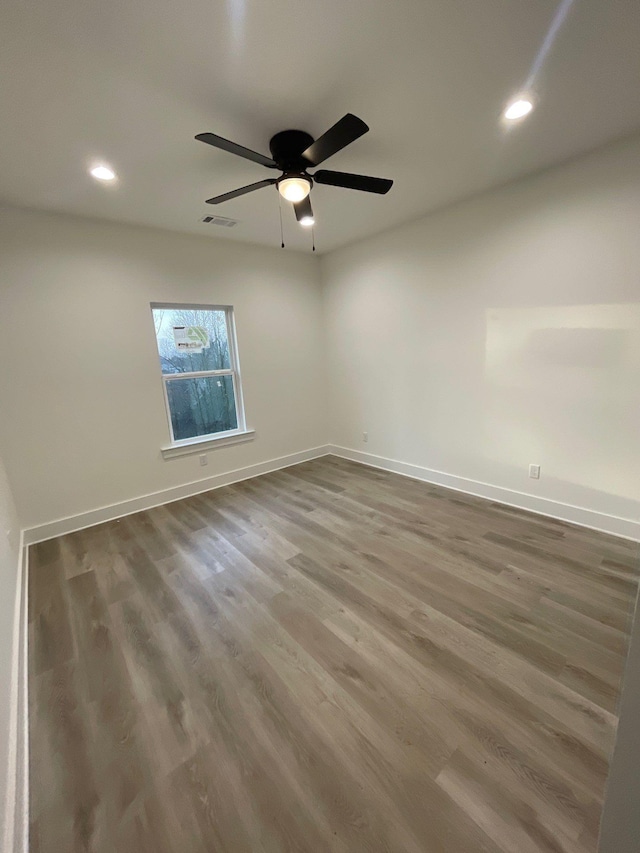 empty room featuring hardwood / wood-style floors and ceiling fan