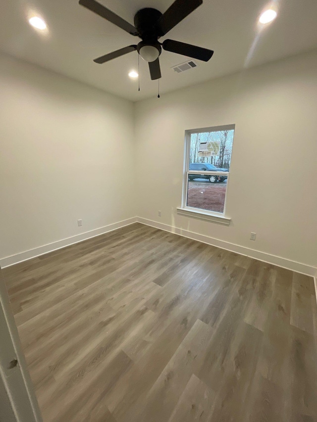 spare room with wood-type flooring and ceiling fan