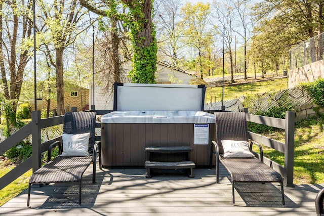 wooden deck featuring a hot tub