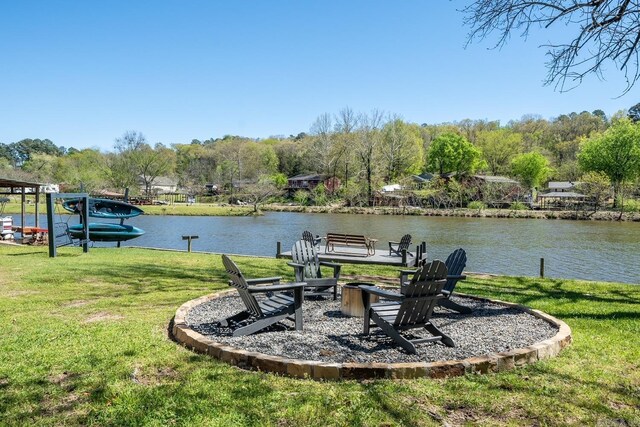 exterior space featuring a water view and a fire pit