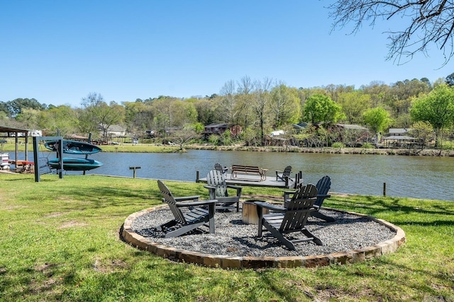 view of yard with a water view and a fire pit