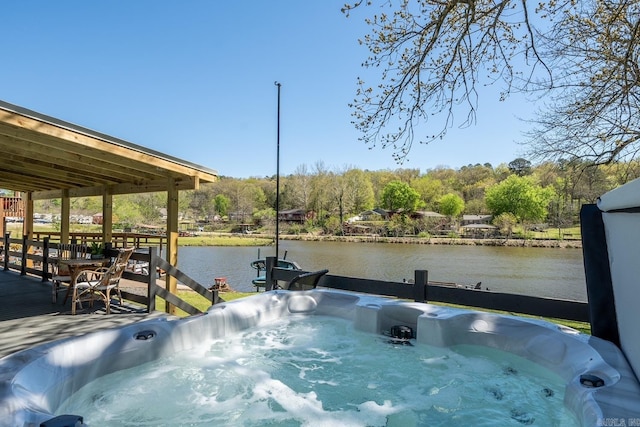 view of dock with a water view and a hot tub