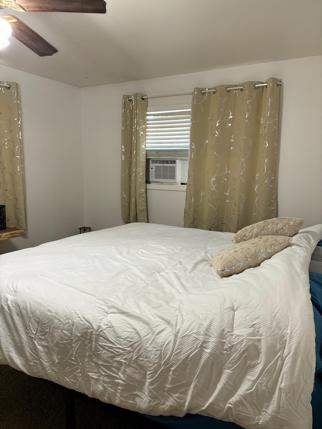 bedroom with cooling unit and ceiling fan