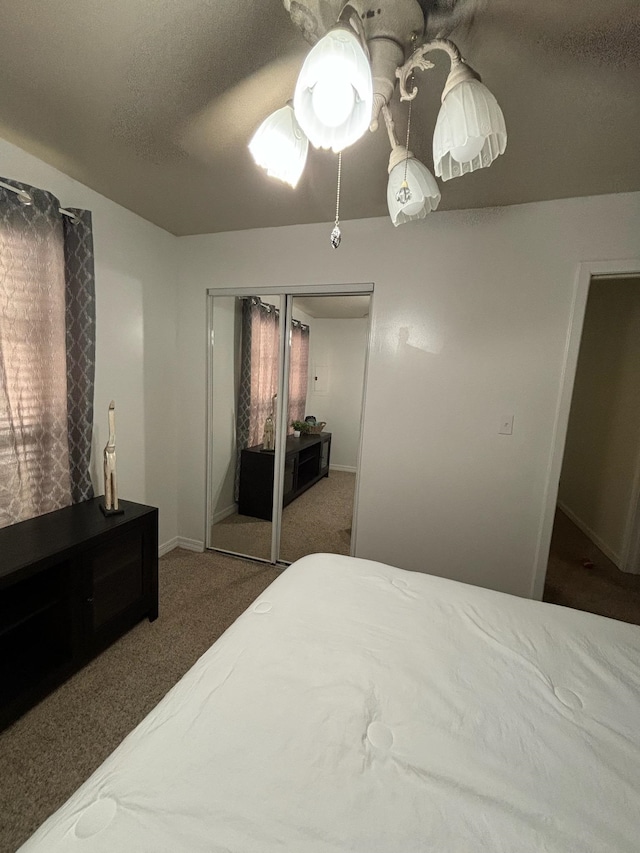 bedroom with carpet flooring, a closet, and ceiling fan