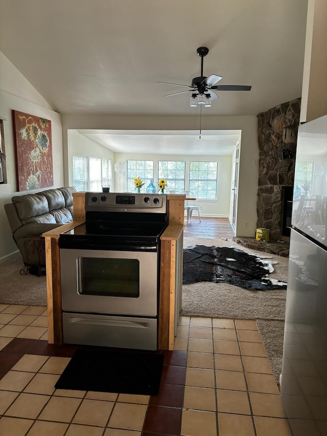 kitchen with tile patterned floors, appliances with stainless steel finishes, ceiling fan, and a healthy amount of sunlight