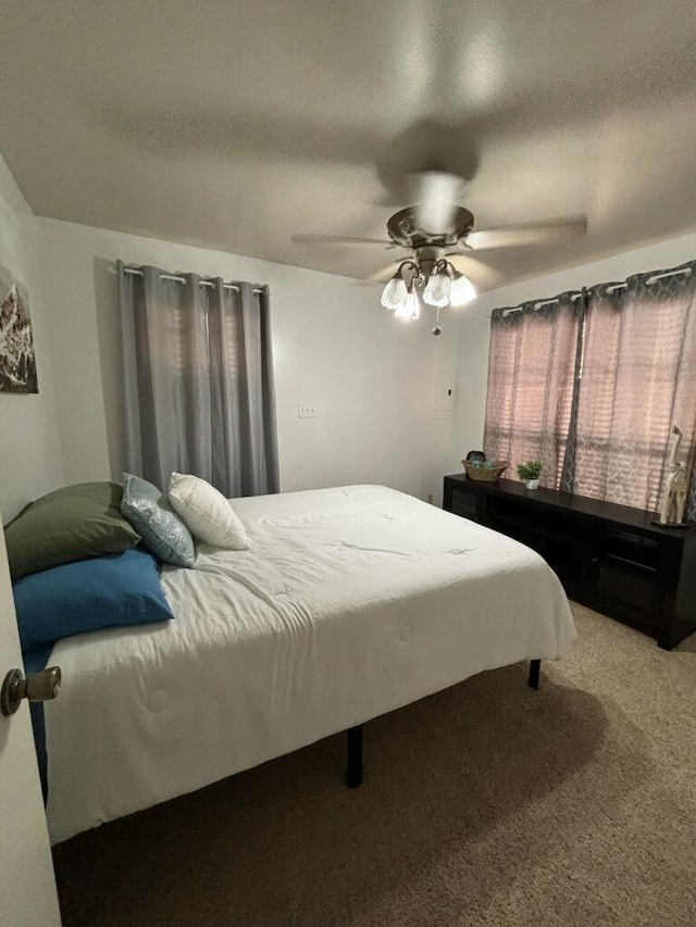 bedroom featuring a textured ceiling, carpet flooring, and ceiling fan