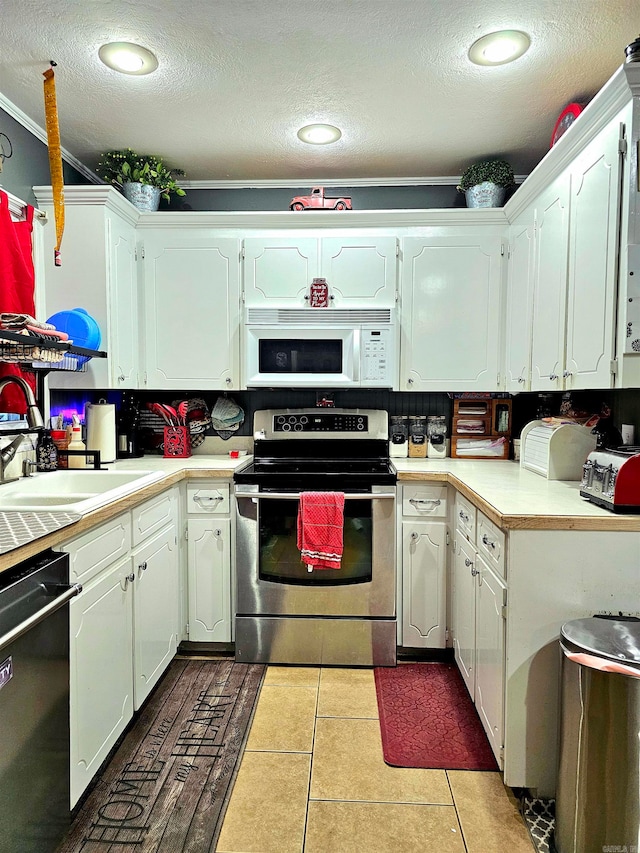 kitchen with dishwasher, white cabinetry, stainless steel electric range, and light tile patterned floors