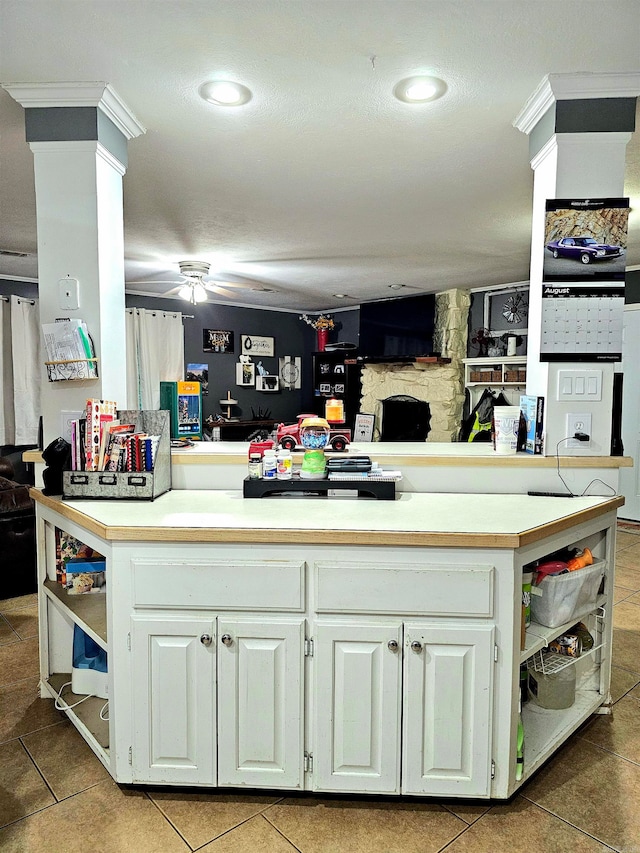 kitchen featuring kitchen peninsula, tile patterned floors, and white cabinets