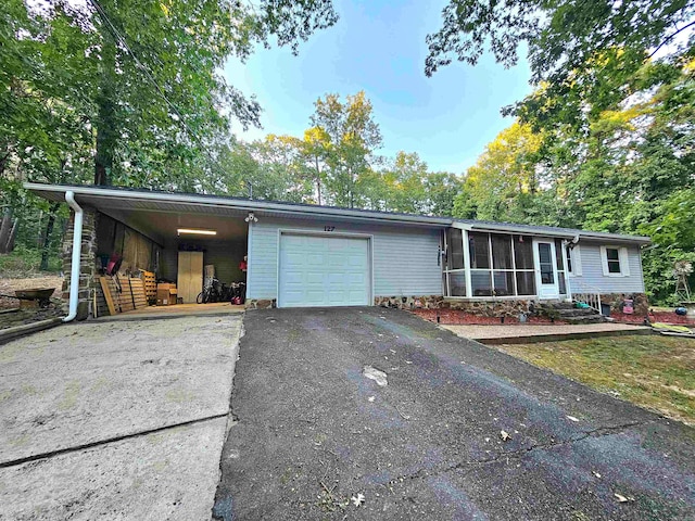 view of front of home with a garage and a carport