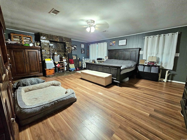 bedroom with light wood-type flooring and a textured ceiling