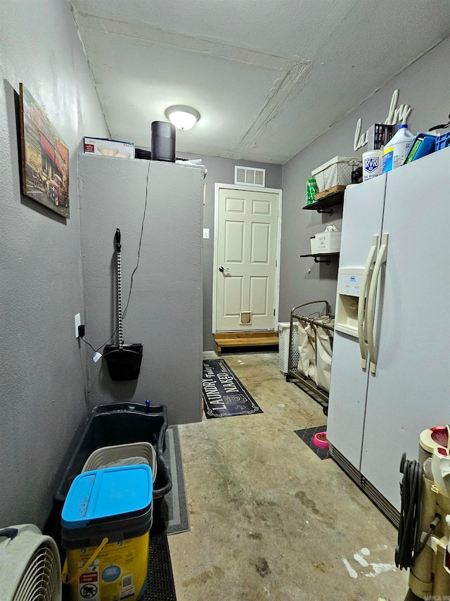 kitchen featuring white fridge with ice dispenser