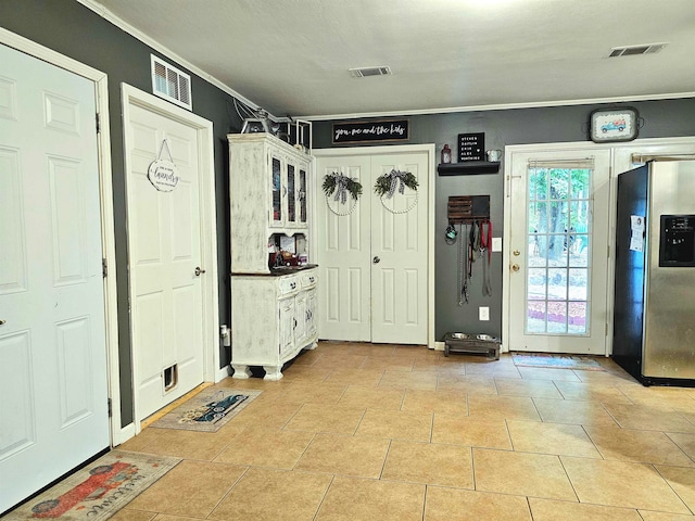 interior space featuring ornamental molding and light tile patterned flooring