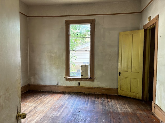 unfurnished room featuring dark hardwood / wood-style floors