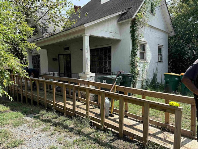 view of home's exterior featuring a porch and a deck