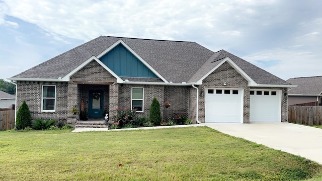 view of front of property featuring a garage, fence, driveway, a front lawn, and board and batten siding