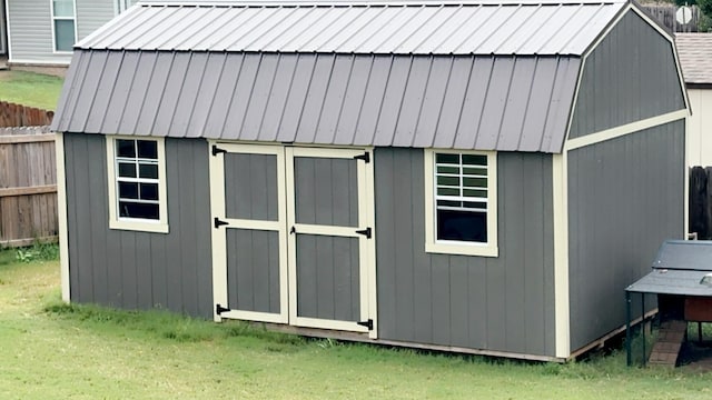 view of shed featuring fence