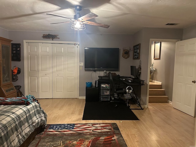 bedroom featuring ceiling fan, a closet, and light hardwood / wood-style floors