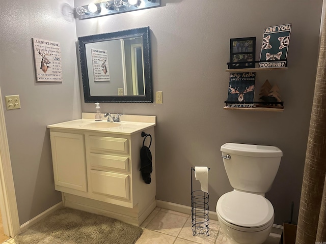 bathroom with vanity, toilet, and tile patterned floors