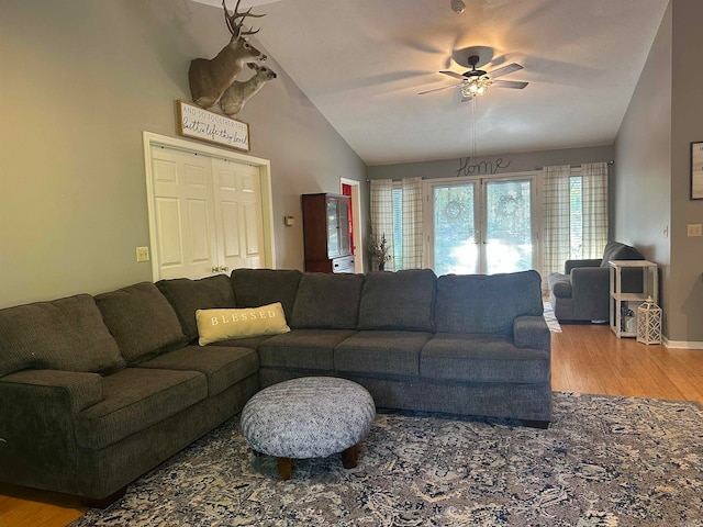 living room featuring lofted ceiling, ceiling fan, and hardwood / wood-style flooring