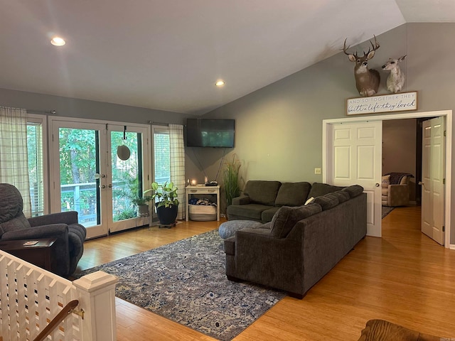 living room with vaulted ceiling and hardwood / wood-style floors