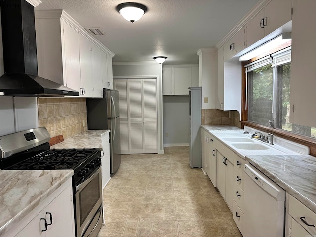 kitchen featuring wall chimney exhaust hood, light tile patterned floors, stainless steel appliances, decorative backsplash, and white cabinetry