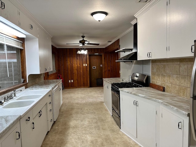 kitchen with white cabinetry, stainless steel appliances, sink, ceiling fan, and light tile patterned flooring