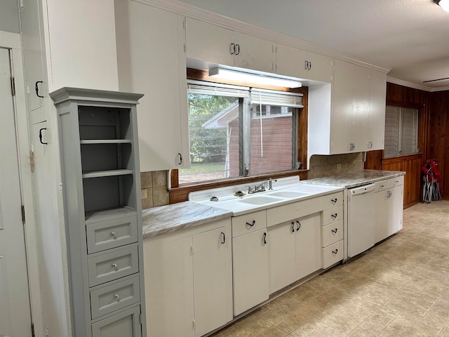 kitchen featuring dishwasher, sink, and light tile patterned flooring