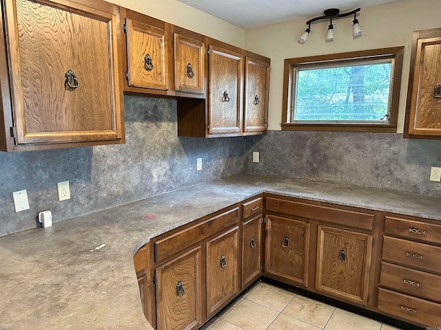 kitchen with backsplash and light tile patterned flooring