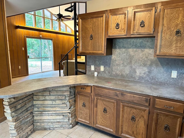 kitchen with ceiling fan, light tile patterned floors, and tasteful backsplash