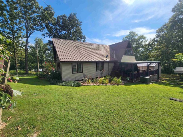 back of house with a lawn