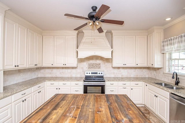 kitchen featuring stainless steel appliances, white cabinetry, sink, ceiling fan, and butcher block counters