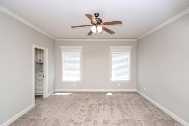 unfurnished room featuring light carpet, crown molding, and ceiling fan