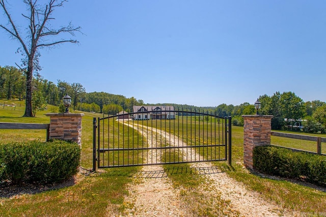 view of gate featuring a lawn