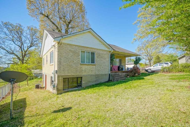 view of home's exterior with a yard and cooling unit